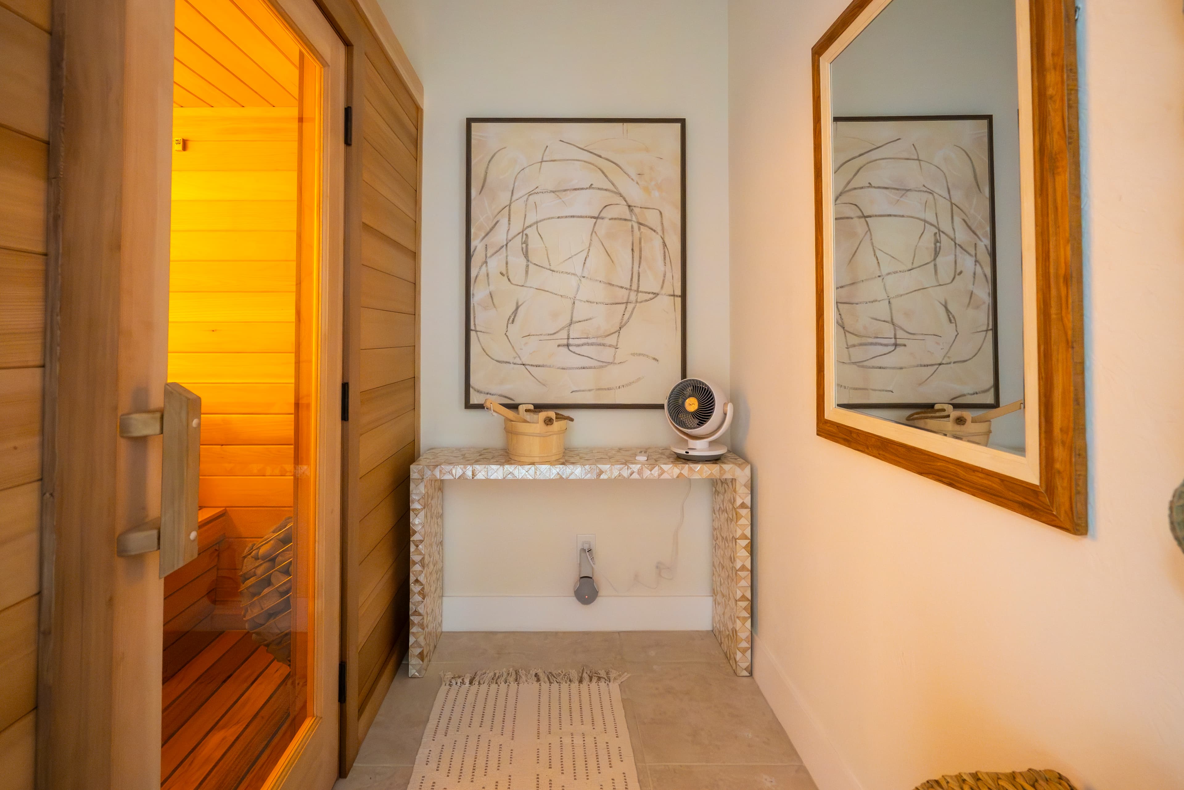 Warm-lit Finnish sauna and entry corridor inside the RINOVA Longevity space in Palm Beach Gardens.